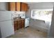 Functional kitchen with basic appliances, wood cabinets, and natural light at 28127 Knowles Rd # Ab&C, Evergreen, CO 80439