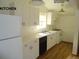 Bright kitchen featuring white cabinets, laminate countertops, and modern appliances at 28127 Knowles Rd # Ab&C, Evergreen, CO 80439