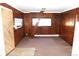 Cozy living area features wood paneling and a window with natural light at 28127 Knowles Rd # Ab&C, Evergreen, CO 80439