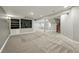 Finished basement with carpet flooring, black media center, and staircase at 2521 N Xenia St, Denver, CO 80238
