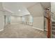 Spacious finished basement includes carpet flooring and staircase at 2521 N Xenia St, Denver, CO 80238