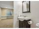 Cozy bathroom with a sleek vanity, a large mirror, and essential storage at 2521 N Xenia St, Denver, CO 80238