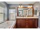 Bathroom with dual sink vanity, dark wood cabinets, and a large mirror for a luxurious feel at 2521 N Xenia St, Denver, CO 80238