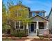 Charming two-story home featuring a covered front porch with white columns and a well-maintained landscaped yard at 2521 N Xenia St, Denver, CO 80238