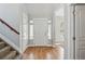 Bright foyer features hardwood floors, a white front door with sidelights, and a staircase with carpeted steps at 2521 N Xenia St, Denver, CO 80238