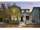 Inviting two-story home with a cozy front porch, well-maintained landscaping, and solar panels at 2521 N Xenia St, Denver, CO 80238