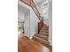 A staircase featuring carpeted steps, a wooden handrail, and a large window providing natural light at 2521 N Xenia St, Denver, CO 80238