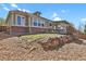 This backyard is sloped and includes a stone wall and an enclosed porch at 2775 S Jebel Way, Aurora, CO 80013