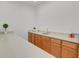 Basement bar with wood cabinets and a sink, ideal for entertaining guests at 2775 S Jebel Way, Aurora, CO 80013
