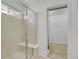 Tiled walk-in shower features a glass enclosure, window, and built-in bench at 2775 S Jebel Way, Aurora, CO 80013
