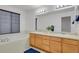 Bright bathroom with double sinks, vanity, and separate tub at 2775 S Jebel Way, Aurora, CO 80013