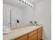 Bright bathroom featuring a light wood vanity, white sink, and modern lighting fixture at 2775 S Jebel Way, Aurora, CO 80013
