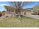 Inviting home exterior with lush lawn and a spacious three-car garage for ample parking at 2775 S Jebel Way, Aurora, CO 80013