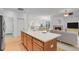 Modern kitchen island with stainless appliances, open to the living and dining areas at 2775 S Jebel Way, Aurora, CO 80013