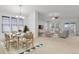 Open-concept living and dining area with abundant natural light from large windows at 2775 S Jebel Way, Aurora, CO 80013