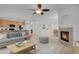 Spacious living room with a fireplace, seamlessly connected to the kitchen and dining area at 2775 S Jebel Way, Aurora, CO 80013