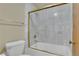 Bright bathroom featuring a bathtub with glass doors and marbled tile walls at 800 N Pearl St # 303, Denver, CO 80203
