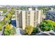 Eye-level aerial view of the apartment building showcasing mature foliage, surrounding neighborhood, and private balconies at 800 N Pearl St # 303, Denver, CO 80203