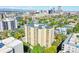 Aerial view of the building with tree coverage, a view of the neighborhood, and downtown city skyline in the background at 800 N Pearl St # 303, Denver, CO 80203