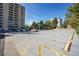 Large parking lot near buildings with spaces marked by yellow lines offering ample parking for residents and guests at 800 N Pearl St # 303, Denver, CO 80203
