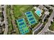 Aerial view of tennis courts and a community pool surrounded by trees and parking at 9867 W Berry Dr, Littleton, CO 80123