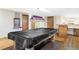 Spacious basement with a billiards table and a bar area, perfect for entertaining at 9867 W Berry Dr, Littleton, CO 80123
