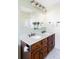 Bathroom with double sink vanity, white countertop, and well-lit mirror at 9867 W Berry Dr, Littleton, CO 80123