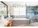 Stylish bathroom with soaking tub, glass shower, granite countertop and modern fixtures at 9867 W Berry Dr, Littleton, CO 80123