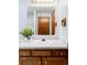 Well-lit bathroom with vanity, a bright mirror, and decor at 9867 W Berry Dr, Littleton, CO 80123
