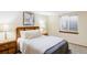 Comfortable bedroom with a wood headboard, soft bedding, and bedside tables at 9867 W Berry Dr, Littleton, CO 80123