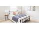 Cozy bedroom featuring a wrought iron bed frame and modern decor, creating a serene and stylish space at 9867 W Berry Dr, Littleton, CO 80123