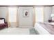 Bright bedroom with neutral tones, large windows, and comfortable furnishings for a relaxing retreat at 9867 W Berry Dr, Littleton, CO 80123