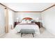 Bright bedroom with a large window, neutral walls, and hardwood trim throughout at 9867 W Berry Dr, Littleton, CO 80123