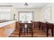 Dining room featuring hardwood floors, wooden table, and natural light from the adjacent windows at 9867 W Berry Dr, Littleton, CO 80123