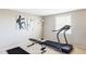 Well-equipped home gym with treadmill, weight bench, and ample space for workouts at 9867 W Berry Dr, Littleton, CO 80123