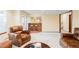 Relaxing living area with comfortable leather seating and access to a bar and outdoor space at 9867 W Berry Dr, Littleton, CO 80123