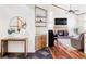 Inviting living room featuring hardwood floors, fireplace, high ceilings and a comfortable seating area at 9867 W Berry Dr, Littleton, CO 80123