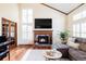 Living room with fireplace, hardwood floors, natural light, and comfortable seating at 9867 W Berry Dr, Littleton, CO 80123