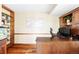 Comfortable office with custom built-ins, shelving, hardwood floors, and natural light at 9867 W Berry Dr, Littleton, CO 80123