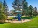 Community playground with a slide and benches, perfect for families with children at 9867 W Berry Dr, Littleton, CO 80123