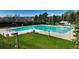 Large community pool with ample seating, lifeguard stand, and a well-maintained lawn area at 9867 W Berry Dr, Littleton, CO 80123