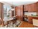 Dining area with wooden floors and a large window, complemented by built-in wood cabinetry at 15844 E Lake Cir, Centennial, CO 80016