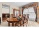 Dining room boasts a wood table with seating for six and lots of light from the adjacent windows at 15844 E Lake Cir, Centennial, CO 80016