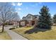 Charming two-story home with a three-car garage, beautiful landscaping, and a spacious front yard at 15844 E Lake Cir, Centennial, CO 80016