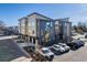 Aerial view of modern townhomes with colorful mural and parking at 2900 W Parkside Pl, Denver, CO 80221