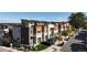 Street view of stylish townhomes featuring private garages, modern design, and lush landscaping at 2900 W Parkside Pl, Denver, CO 80221