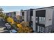 Attractive street view of modern townhomes with colorful fall foliage and convenient street parking at 2900 W Parkside Pl, Denver, CO 80221