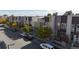 Modern townhomes with contemporary designs line a street with mature trees and parked cars at 2900 W Parkside Pl, Denver, CO 80221