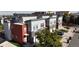 Aerial street view showcasing modern townhomes with eye-catching colors, attached garages and landscaping at 2900 W Parkside Pl, Denver, CO 80221