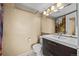 Bathroom includes a vanity with storage, mirror, towel rack, and shower at 17118 E Whitaker Dr # E, Aurora, CO 80015